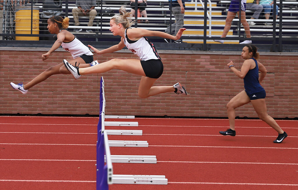 Meaghan Hammonds and Riley Schonhardt jump over hurdles